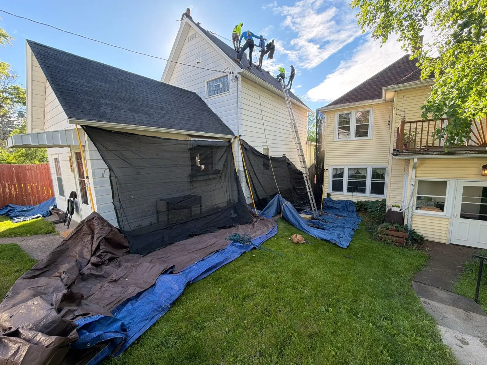 Covenant Builders crew replacing a roof on a Hermantown home